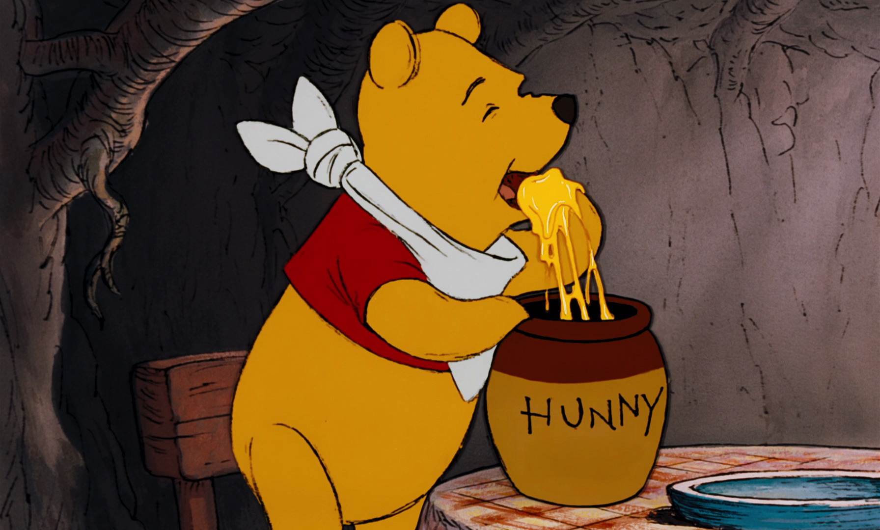 Winnie the Pooh is about to eat honey